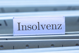 (Photomontage) Sign with the inscription INSOLVENCE on a suspension file folder