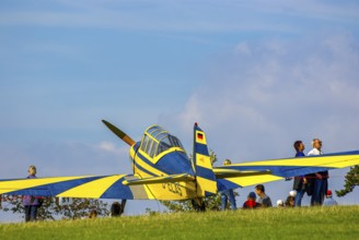 A Moravan Zlin Z126 multi-purpose aircraft parked at the edge of the airfield during an air show at
