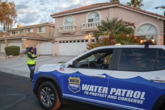 Las Vegas, Nevada - Devyn Choltko, a water waste investigator, patrols a residential neighborhood,