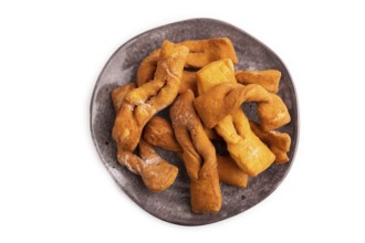 Crunchy biscuit Brushwood cookies sprinkled with powdered sugar isolated on white background, top