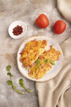 Baked chicken meat with cheese and tomatoes on brown concrete background and linen textile. top