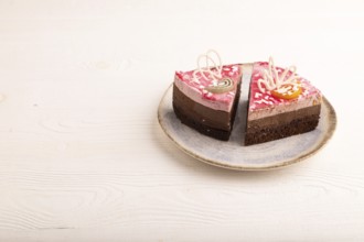 Chocolate cake on white wooden background, side view, copy space