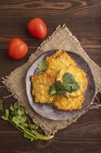 Fried crispy Chicken pancakes on brown wooden background and linen textile. top view, flat lay,