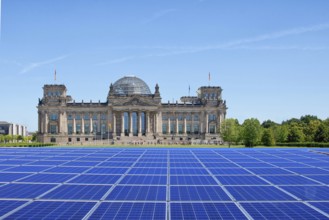 Symbolic image, solar park in the city, Reichstag building Berlin with modules on the green area,