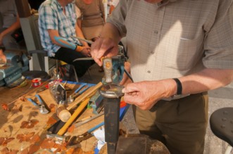 Tinsmith at work, old trade, tinsmiths or plumbers are craftsmen who take care of metal products.