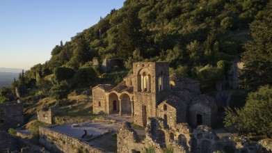 Church of Agia Sophia from the 14th century AD, An ancient church and ruins are bathed in warm