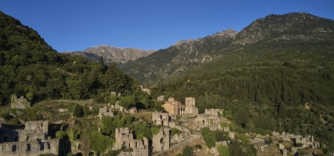 Drone shot, Ancient ruins in a mountainous and wooded environment in sunny weather, including the