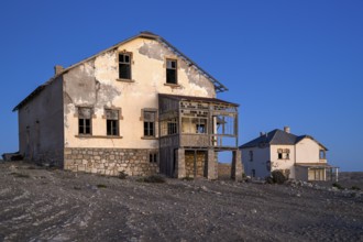 Dilapidated buildings in the desert sand, blue hour, Kolmanskop, near Lüderitz, Karas region,