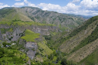Green mountain landscape with deep gorges under blue sky and clouds, Garni Gorge, Azat River,
