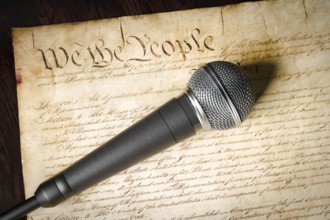 Microphone resting on the U.S. constitution