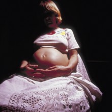 Pregnant woman with her hands on her stomach, Bavaria, Germany