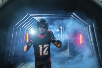 American football player with helmet and uniform running from a smoky tunnel with blue and red