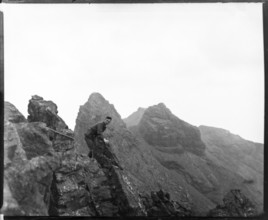 Climber on rocks, Cuillin mountains, Skye, Scotland, UK c 1900-1920 colourised image