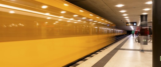 Dynamic scene of a Berlin underground in typical yellow colour, long exposure with blur effect,