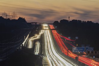 Motorway near Stuttgart with several lanes in the evening with sunset. Heavy traffic with light