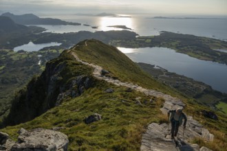 Woman with hiking poles walking up Rørsethornet stone stairs, with 3292 steps one of the longest