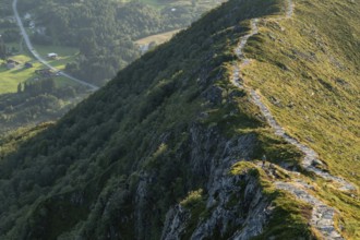 Woman standing on section of the Rørsethornet stone staircase, with 3292 steps one of the longest