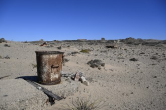 Rusted bucket in the desert sand, Pomona, restricted diamond area, near Lüderitz, Karas region,