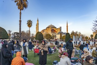 Muslims at an evening Ramadan picnic in the park in front of the Hagia Sophia mosque in Istanbul,