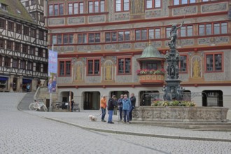 Renaissance town hall with Neptune fountain, market stall and pedestrians, Am Markt, Tübingen,
