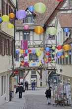 Houses in the Marktgasse with colourful lanterns, decoration, balloons, pedestrians, city museum,