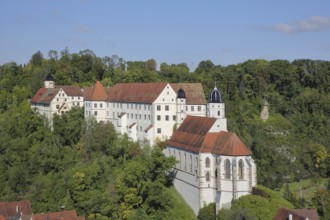 Castle and baroque castle church of St Trinitatis and rock formation, Kapf with cross, Haigerloch,