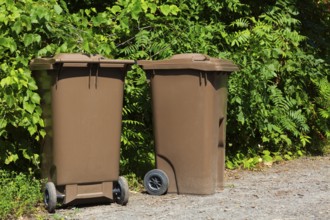 Brown plastic portable composting bins for depositing organic materials and leftover foods in,