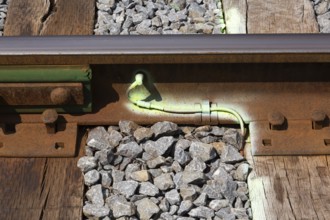 Close-up of ballast and bright green fluorescent spray painted metal ground wire attached to rusted