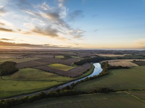 Sunset of Farms and Fields over Norham Castle from a drone, Norham, River Tweed, Northumberland,