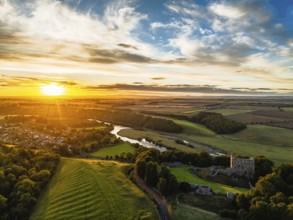 Sunset over Norham Castle and River Tweed from a drone, Norham, Northumberland, England, United