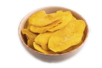 Dried Mango in ceramic bowl isolated on white background. Side view, close up, flat lay. healthy