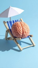 Brain relaxes on a sunbed under the summer sun, placed on a flat surface, symbol for mental health,