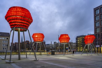 Illuminated sculptures of Dortmund roses in front of Dortmund's landmark U at dusk, Dortmund, North