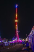 An impressive illuminated ride at a night fair, Cannstatter Wasen funfair, Stuttgart, Germany