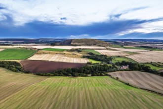 Sunset of Fields and Farms over Traprain Law and Hailes Castle from a drone, River Tyne,