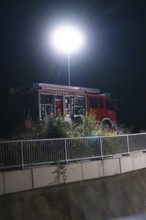 Fire engine under strong spotlight near a railing, fire drill in the new tunnel of the Hermann