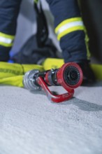 Close-up of a fire hose on the ground, ready for action, fire drill in the new construction tunnel
