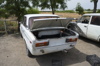 Car parked on a dusty road with the boot open, driving without a licence plate, Armenia
