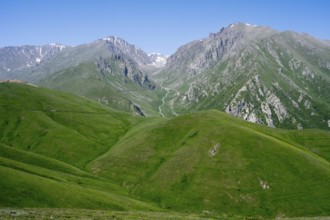 Green hills and majestic mountains under a clear blue sky, at the highest pass in Armenia, Meghri