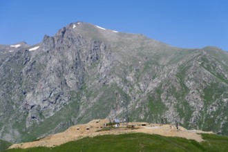 Rocks and antennas with towering mountains in the background, at the highest pass in Armenia,