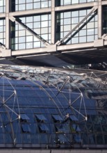 Three male glass cleaners cleaning a glass roof at Berlin Central Station, Berlin, Germany
