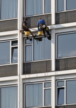 Two male glass cleaners abseiling down the hotel façade to clean windows, aletto Hotel Kudamm,