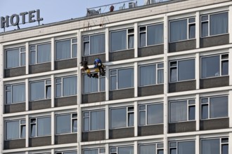 Two male glass cleaners abseiling down the hotel façade to clean windows, aletto Hotel Kudamm,