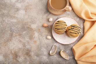 Caramel Cream Cakes on brown concrete background, cup of coffee, top view, flat lay, copy space