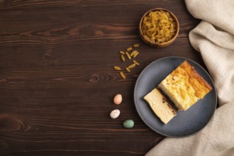 ?ottage cheese ?asserole, Curd cake, with dried apricots and raisins on brown wooden background and