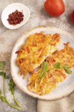 Baked chicken meat with cheese and tomatoes on brown concrete background and linen textile. side