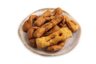 Crunchy biscuit Brushwood cookies sprinkled with powdered sugar isolated on white background, side