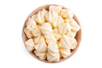 Orange and pink marshmallow in ceramic bowl isolated on white background, top view, flat lay, copy