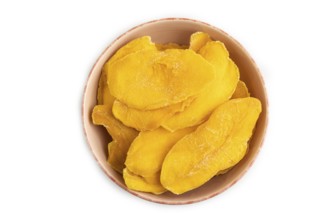 Dried Mango in ceramic bowl isolated on white background. Top view, close up, flat lay. healthy