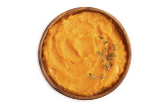 Sweet potato porridge in wooden bowl isolated on white background. Diet, healthy eating concept.